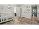 Bedroom showcasing hardwood flooring, a large doorway to the hallway and closet at 126 W Warfield Dr, Mooresville, NC 28115