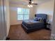 Comfortable bedroom featuring a plush bed and a large window for natural light at 126 W Warfield Dr, Mooresville, NC 28115