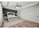 Elegant primary bedroom showcasing dark wood accent wall, tray ceiling, and ample space at 126 W Warfield Dr, Mooresville, NC 28115