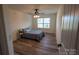 Cozy bedroom with wood-look floors, ceiling fan and natural light from a large window at 126 W Warfield Dr, Mooresville, NC 28115