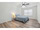 Cozy bedroom with ample natural light, light wood floors, and ceiling fan at 126 W Warfield Dr, Mooresville, NC 28115
