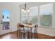 Charming dining area featuring hardwood floors, white walls, and natural light from three large windows at 126 W Warfield Dr, Mooresville, NC 28115
