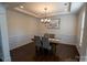 Formal dining room featuring modern lighting, beautiful wood floors and wainscoting at 126 W Warfield Dr, Mooresville, NC 28115