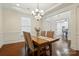 Formal dining room with hardwood floors, wainscoting, and decorative lighting at 126 W Warfield Dr, Mooresville, NC 28115