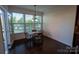Dining area filled with natural light, showcasing a table with chairs and large windows with backyard views at 126 W Warfield Dr, Mooresville, NC 28115