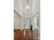 Bright, two-story foyer with hardwood floors and transom window above the front door at 126 W Warfield Dr, Mooresville, NC 28115