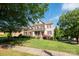 Charming two-story home with red shutters, well-manicured lawn and beautiful landscaping at 126 W Warfield Dr, Mooresville, NC 28115