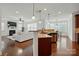 Open concept kitchen with granite countertops, stainless steel appliances, and adjacent living room at 126 W Warfield Dr, Mooresville, NC 28115