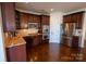 Well-equipped kitchen with stainless steel appliances, granite countertops, and dark wood cabinetry at 126 W Warfield Dr, Mooresville, NC 28115