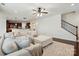 Open-concept living room boasts a large sectional and hardwood floors; staircase view at 126 W Warfield Dr, Mooresville, NC 28115