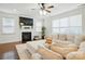 Bright living room features a fireplace, large windows, and a neutral sectional sofa at 126 W Warfield Dr, Mooresville, NC 28115
