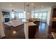 Open-concept living area with kitchen island, stainless steel sink, and view of the fireplace in the living room at 126 W Warfield Dr, Mooresville, NC 28115