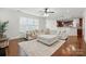 Open-concept living room boasts a large sectional and hardwood floors; kitchen view at 126 W Warfield Dr, Mooresville, NC 28115