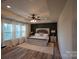 A serene main bedroom with wood floors and natural light at 126 W Warfield Dr, Mooresville, NC 28115