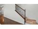 Staircase with wood steps and an iron railing, complemented by hardwood flooring at 126 W Warfield Dr, Mooresville, NC 28115