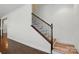 Staircase with wood steps and an iron railing, complemented by hardwood flooring at 126 W Warfield Dr, Mooresville, NC 28115
