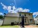 Backyard view of home features patio area, grassy area, and beautiful blue skies at 13241 Woodland Farm Dr, Charlotte, NC 28215