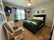 Bedroom with bright natural light, comfortable furniture, and carpeted floors at 13241 Woodland Farm Dr, Charlotte, NC 28215