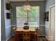 Eat-in dining area with wood table, bright natural light, and views to outdoor space at 13241 Woodland Farm Dr, Charlotte, NC 28215