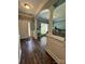 Inviting home entryway with hardwood floors, modern wainscoting and archway at 13241 Woodland Farm Dr, Charlotte, NC 28215