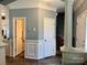 Hallway featuring wood floors, white columns, crown molding and wainscoting at 13241 Woodland Farm Dr, Charlotte, NC 28215