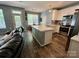 Open kitchen with stainless steel appliances, large island, and wood floors at 13241 Woodland Farm Dr, Charlotte, NC 28215