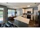 Contemporary kitchen with white cabinets, quartz countertops, and stainless steel appliances at 13241 Woodland Farm Dr, Charlotte, NC 28215