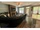 Cozy living room with stone fireplace, ceiling fan and view to exterior at 13241 Woodland Farm Dr, Charlotte, NC 28215