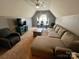 Cozy upstairs living room featuring lounge furniture, television, and bright natural light at 13241 Woodland Farm Dr, Charlotte, NC 28215