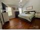 Spacious main bedroom with hard wood floors, vaulted ceilings, and bright natural light at 13241 Woodland Farm Dr, Charlotte, NC 28215