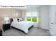 Cozy bedroom with a queen bed, neutral decor, carpeted floors, and a bright window overlooking a green space at 1365 Secrest Commons Dr, Monroe, NC 28112