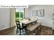Bright dining area with a modern table, seating for six, and a view of the backyard at 1365 Secrest Commons Dr, Monroe, NC 28112
