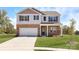 Charming two-story home with brick accents, a two-car garage, and a well-maintained lawn at 1365 Secrest Commons Dr, Monroe, NC 28112