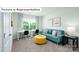 Inviting flex room with a blue couch, accent pillows, work tables and a bright window view at 1365 Secrest Commons Dr, Monroe, NC 28112