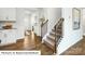 Inviting foyer featuring wood flooring and a staircase that leads to the upper level, perfect for greeting guests at 1365 Secrest Commons Dr, Monroe, NC 28112
