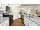 Modern kitchen with stainless steel appliances, granite countertops, and white cabinets at 1365 Secrest Commons Dr, Monroe, NC 28112