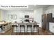 Bright kitchen featuring granite countertops, an island with seating, and stainless steel appliances at 1365 Secrest Commons Dr, Monroe, NC 28112