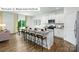 Modern kitchen with a large island, seating, stainless steel appliances, and an open dining area at 1365 Secrest Commons Dr, Monroe, NC 28112
