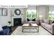 Cozy living room featuring a fireplace, large windows, and elegant furnishings for a welcoming atmosphere at 1365 Secrest Commons Dr, Monroe, NC 28112