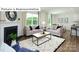 Inviting living room with fireplace, bright windows, and an open layout to the kitchen, perfect for modern living at 1365 Secrest Commons Dr, Monroe, NC 28112