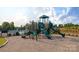 Community playground with slides, climbing structures, and a safety-surface ground covering at 1365 Secrest Commons Dr, Monroe, NC 28112