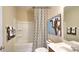 A well-lit bathroom featuring a tub-shower combo, vanity with sink, toilet, and a unique cow-themed artwork at 141 Way Cross Ln, Troutman, NC 28166