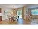 Inviting dining room with a round table, modern chandelier, and sliding glass doors to the backyard at 141 Way Cross Ln, Troutman, NC 28166