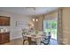 Open dining area with easy access to kitchen, featuring a round table, and sliding glass doors to the backyard at 141 Way Cross Ln, Troutman, NC 28166