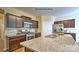 Modern kitchen featuring stainless steel appliances, granite countertops, and dark wood cabinetry for ample storage at 141 Way Cross Ln, Troutman, NC 28166