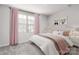 Charming bedroom with soft pink accents, a large window, and cozy bedding at 1430 Samuel St, Charlotte, NC 28206