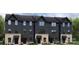 Charming townhome exterior showcasing a brick foundation and dark siding at 1430 Samuel St, Charlotte, NC 28206