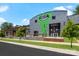 The Heist Brewery and Barrel Arts building with green accents, trees, and sidewalk at 1430 Samuel St, Charlotte, NC 28206