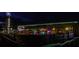 Exterior of a building with string lights, wooden fence and covered patio area at night at 1430 Samuel St, Charlotte, NC 28206