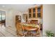 Cozy dining area with tile floors, wood table and decorative glass-front cabinet at 14340 Kendalton Meadow Dr, Mint Hill, NC 28227
